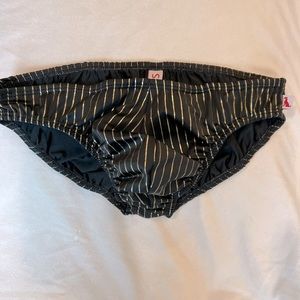 Men’s swim brief, black with gold stripes. Men’s size small.